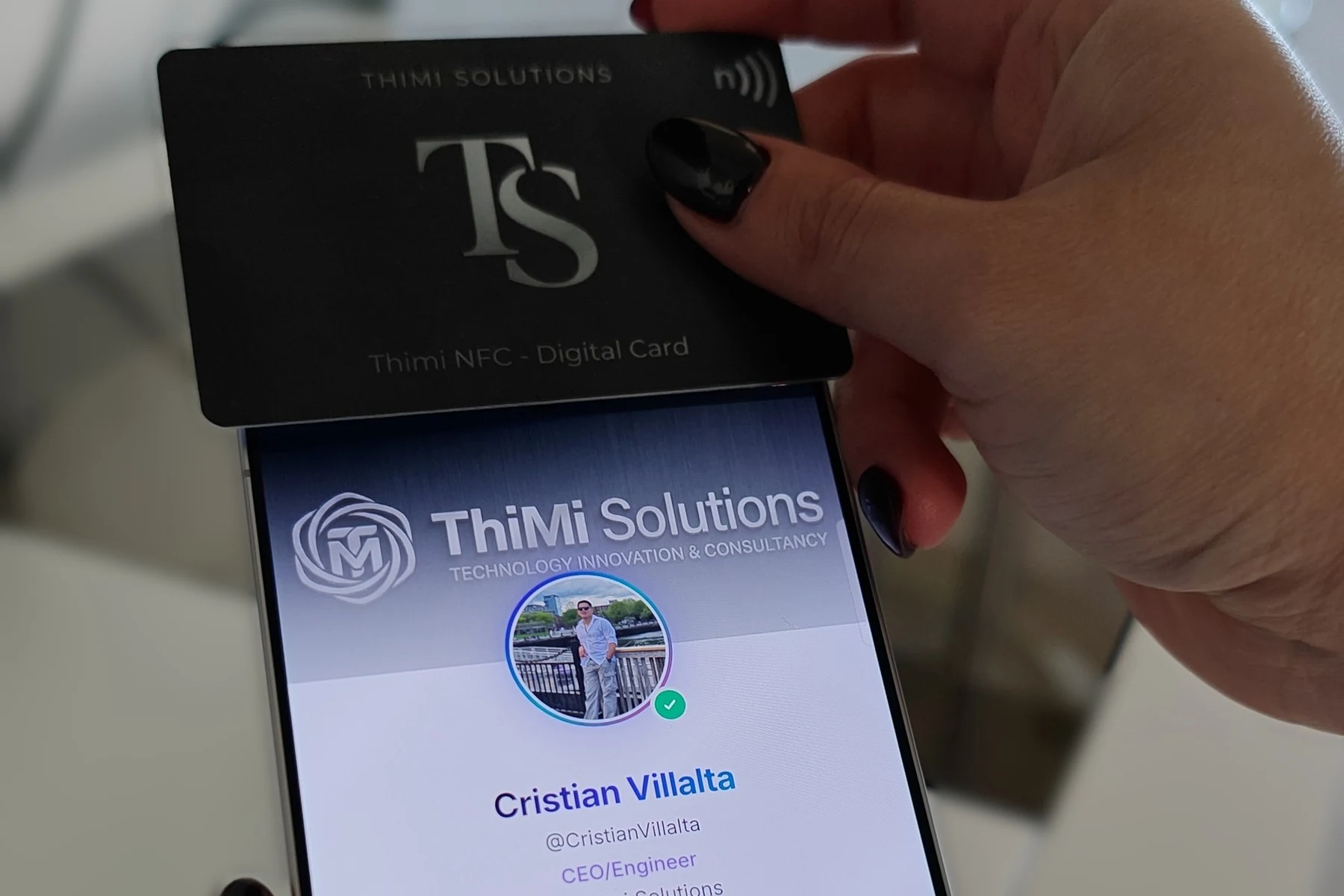 Thimi NFC card held against a phone showing the profile of Cristian Villalta.